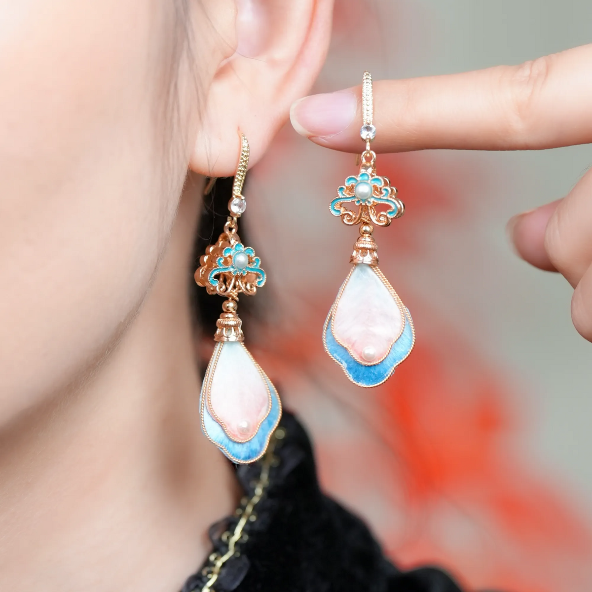 Peach blossom silk velvet drop earrings worn by a model