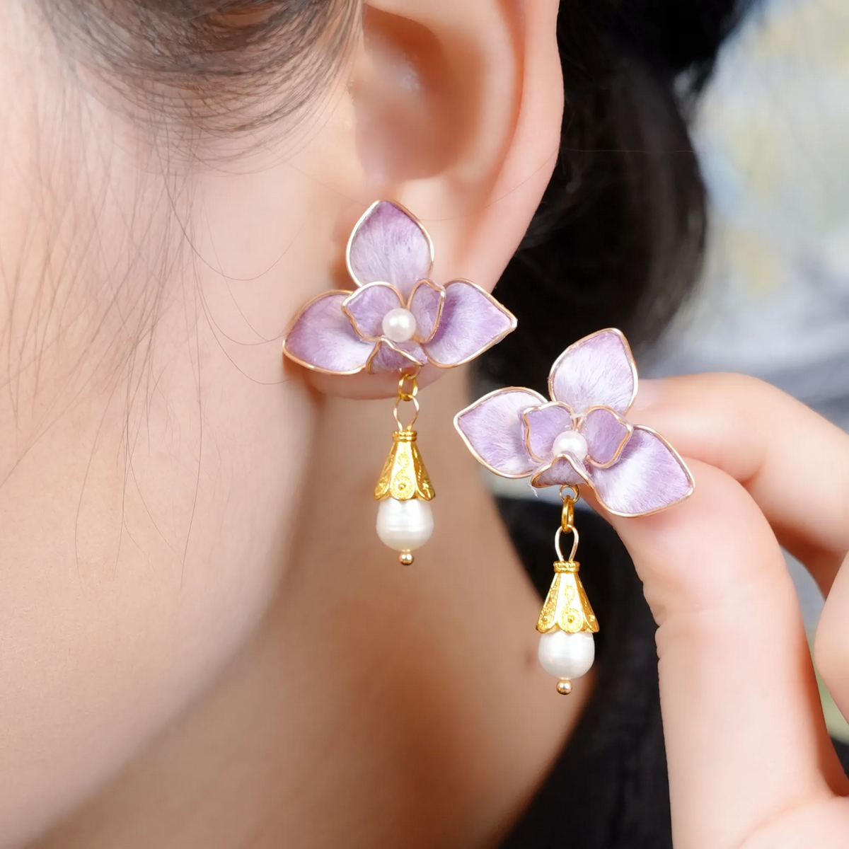 Purple butterfly orchid silk velvet drop earrings worn by a model