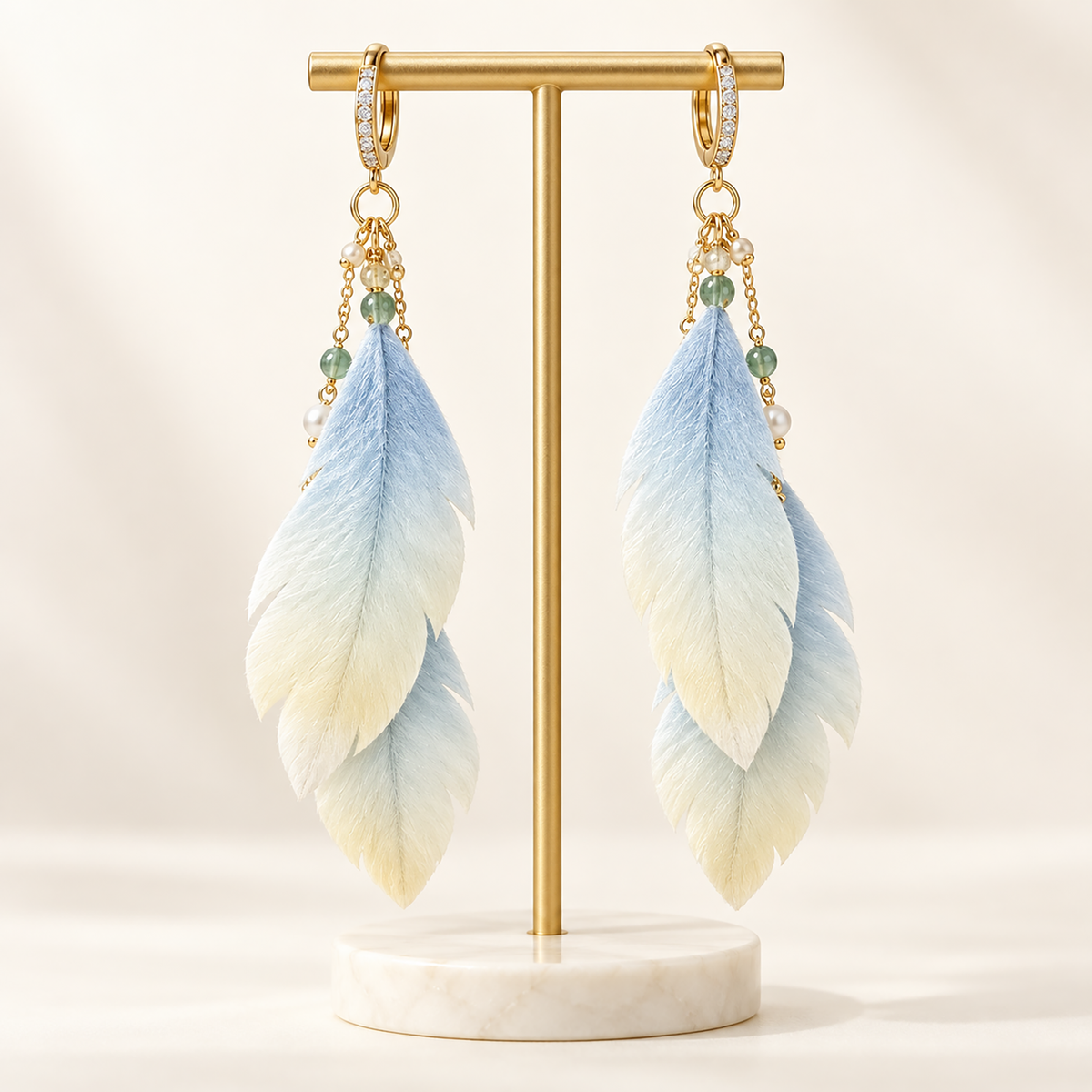 Pair of blue-to-ivory mulberry-silk Ronghua drop earrings on a gold stand