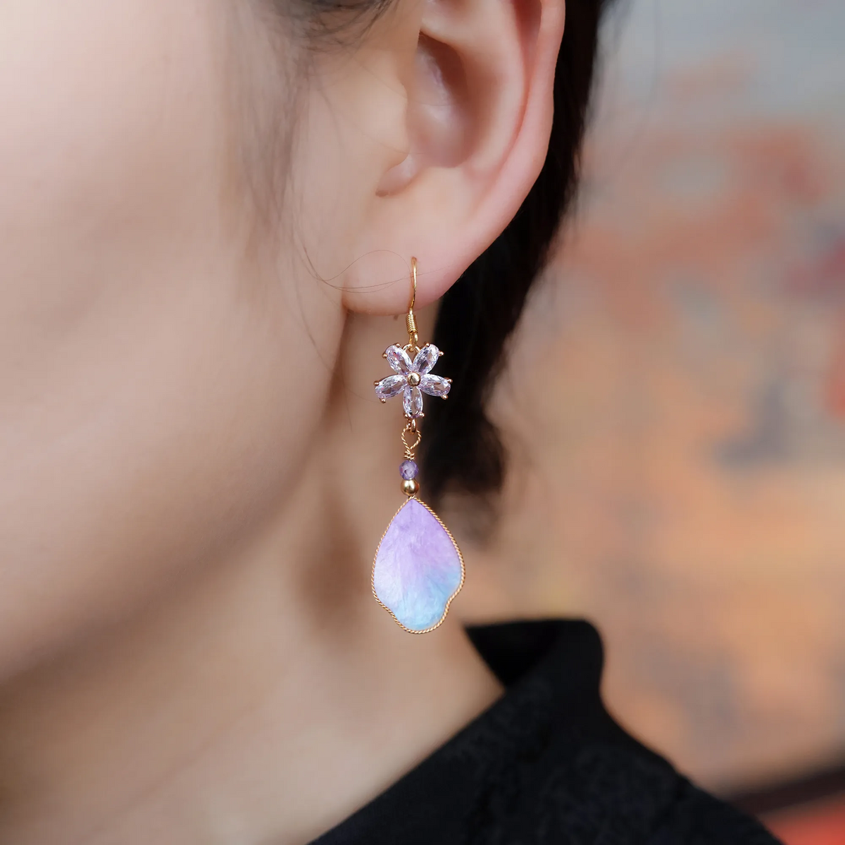 Close-up of purple cloud silk velvet earrings being worn