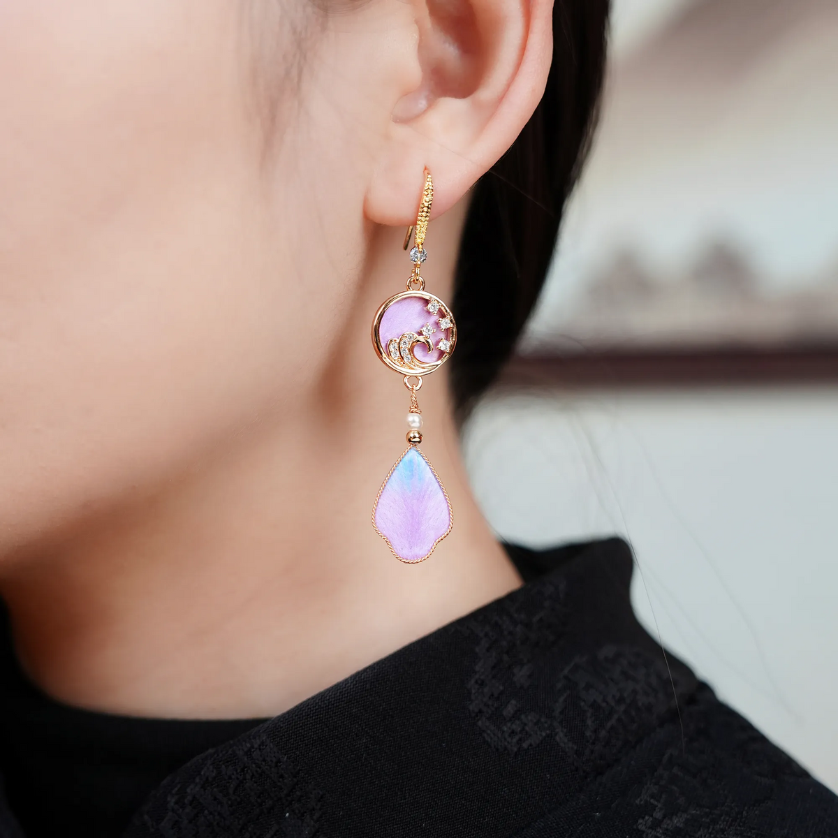 Close-up of purple rosy cloud silk velvet earrings being worn
