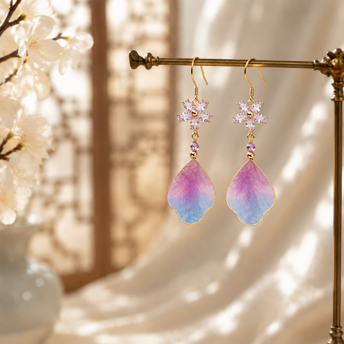 Purple cloud silk velvet drop earrings on a display stand