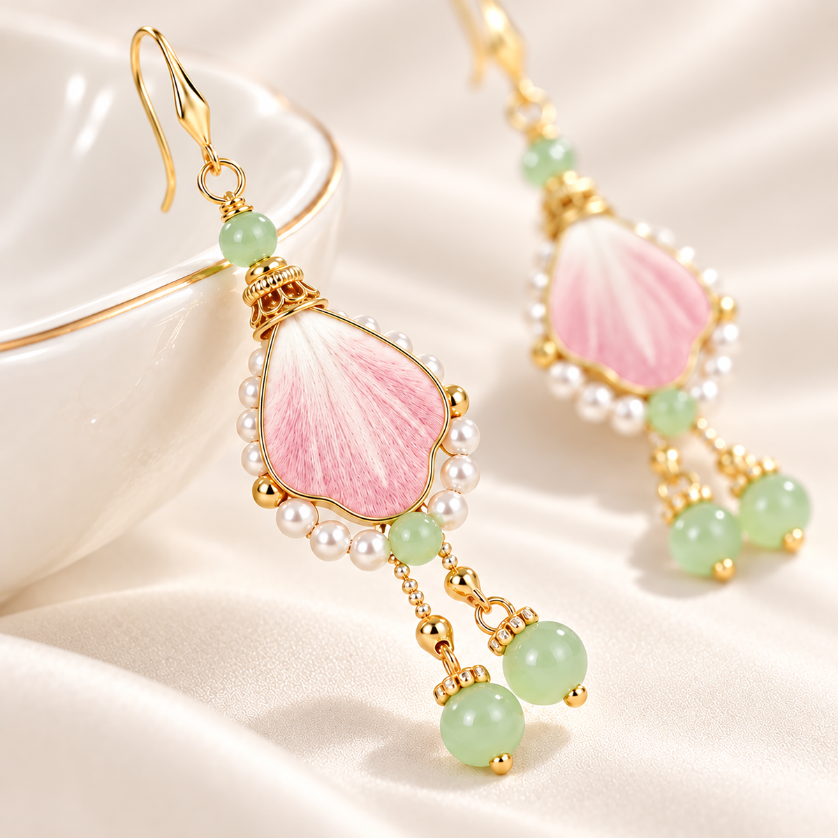 Close view of the pink silk centre, pearl-effect border and green bead drops