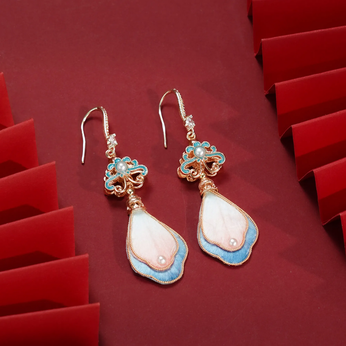 Angled view of peach blossom earrings showing layered petals