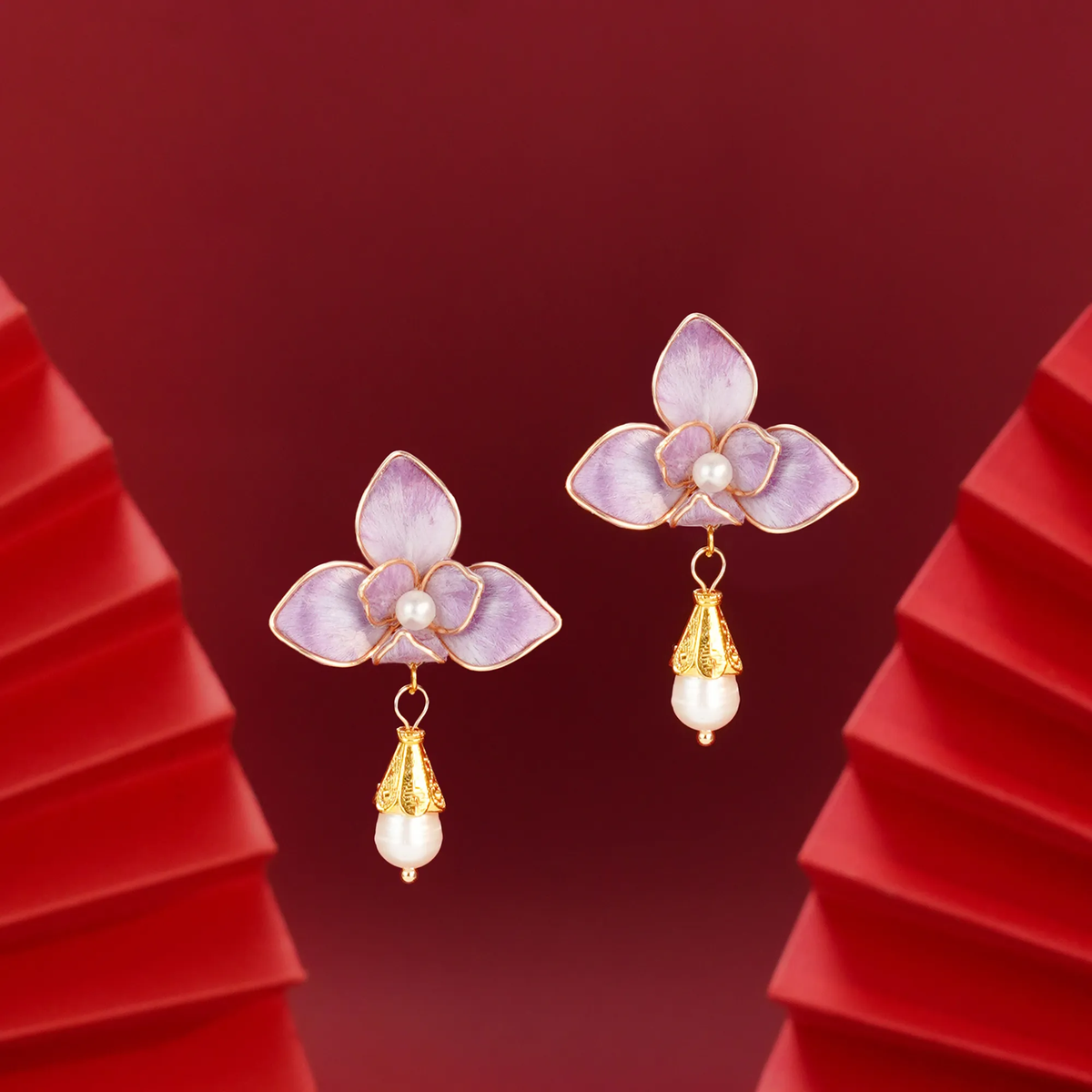 Angled view of purple butterfly orchid silk velvet earrings