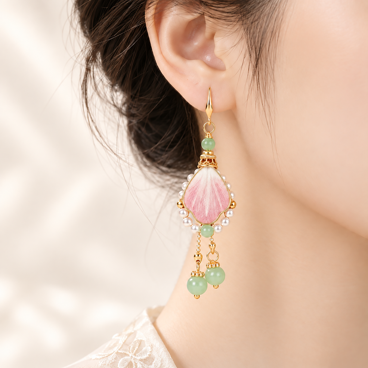 One pink silk Ronghua drop earring worn at the ear