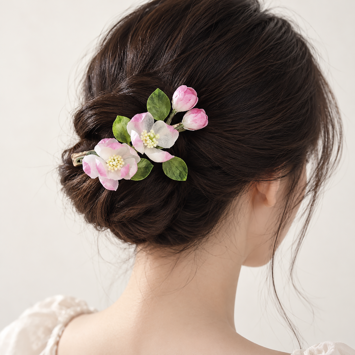 Spring blossom silk Ronghua hair clip worn in a low bun