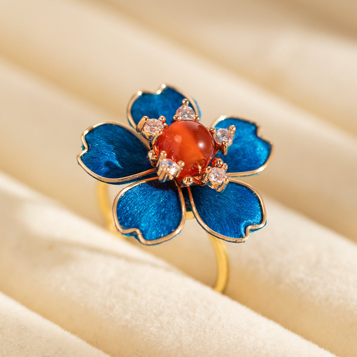 Handcrafted blue Ronghua floral ring displayed on dark wood