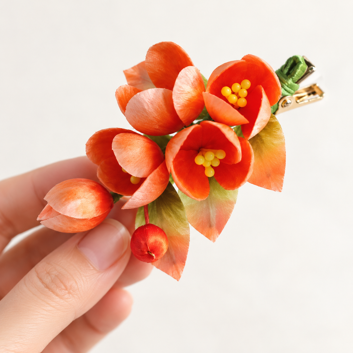 Orange blossom hair clip held in hand