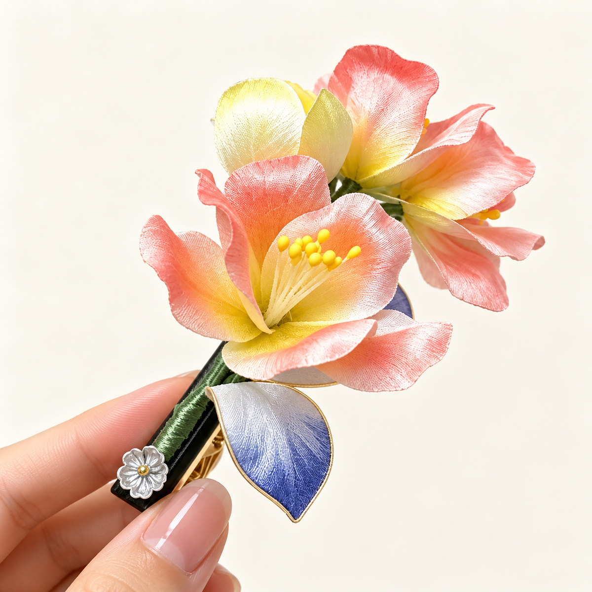 Coral-pink mulberry-silk Ronghua hair clip held in hand