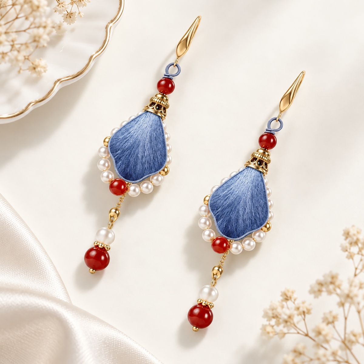 Blue silk petal drop earrings with red beads and pearl-like accents
