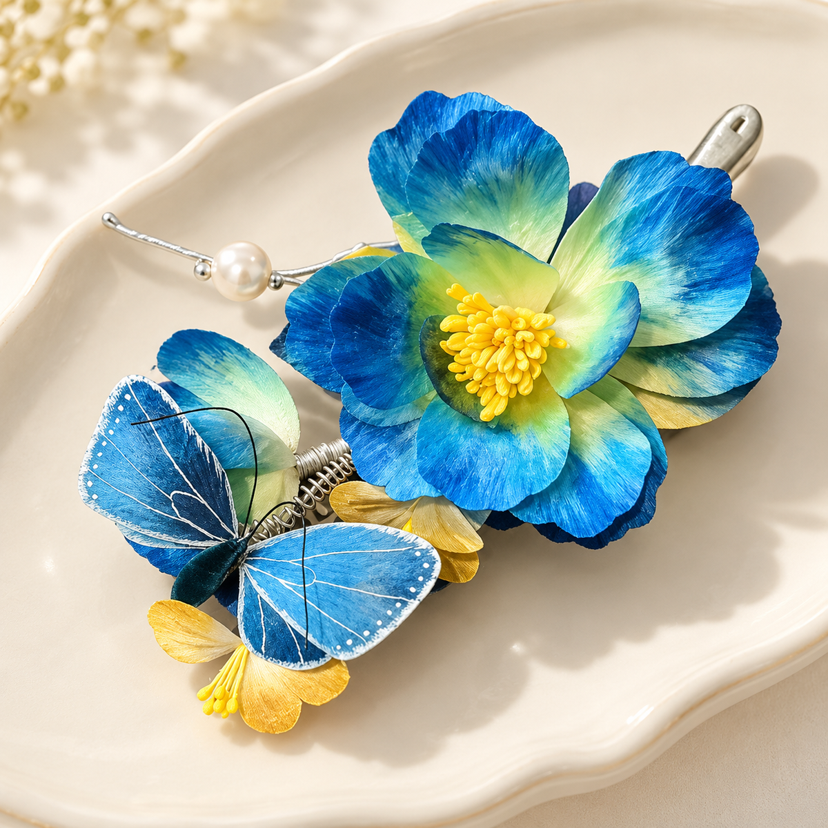 Blue blossom butterfly hair clip on a ceramic plate