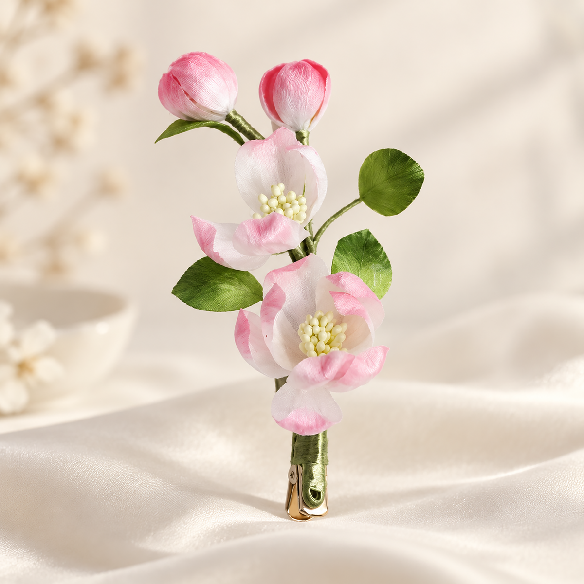 White-to-pink Ronghua blossoms with green leaves close-up