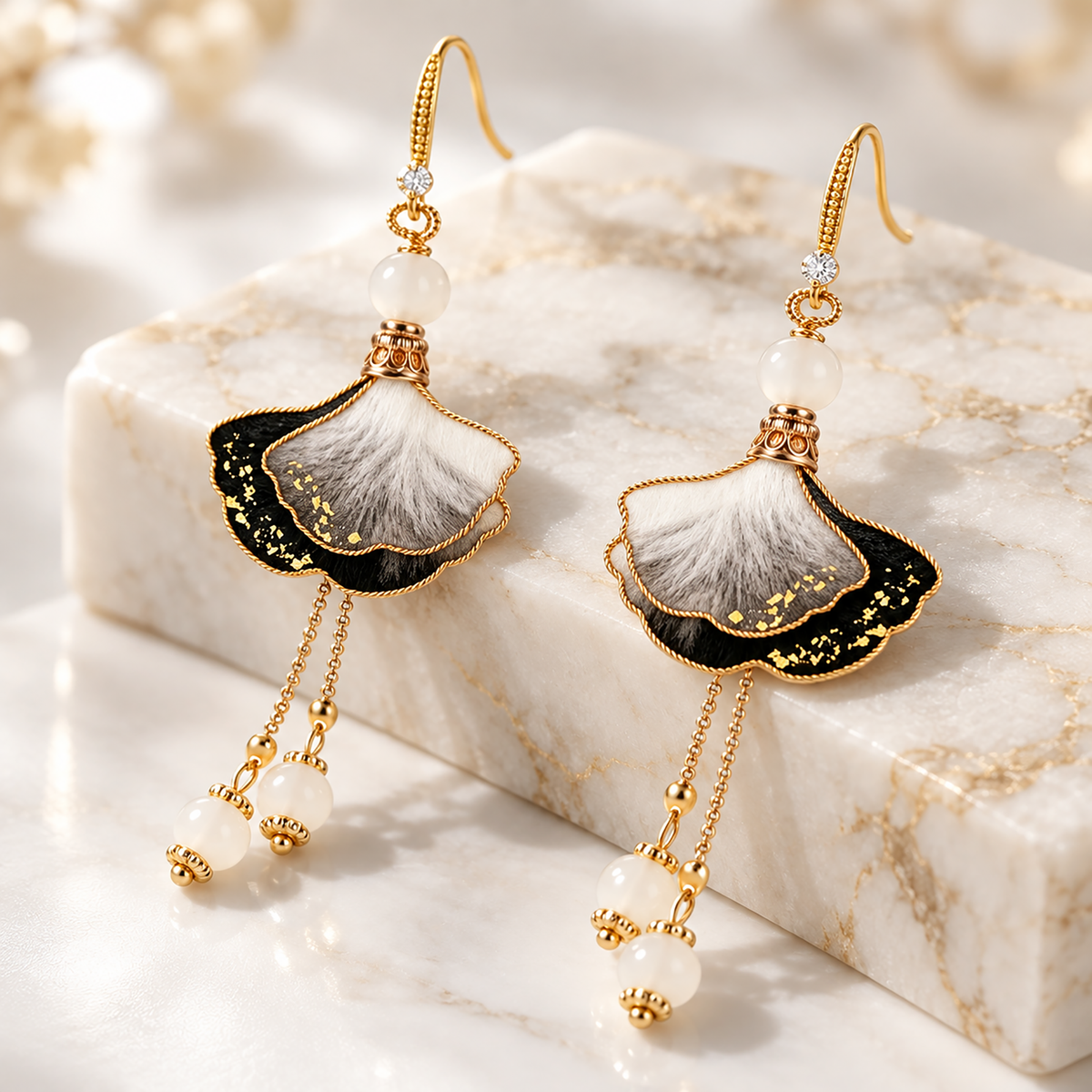 Ink-wash ginkgo silk drop earrings on a marble block