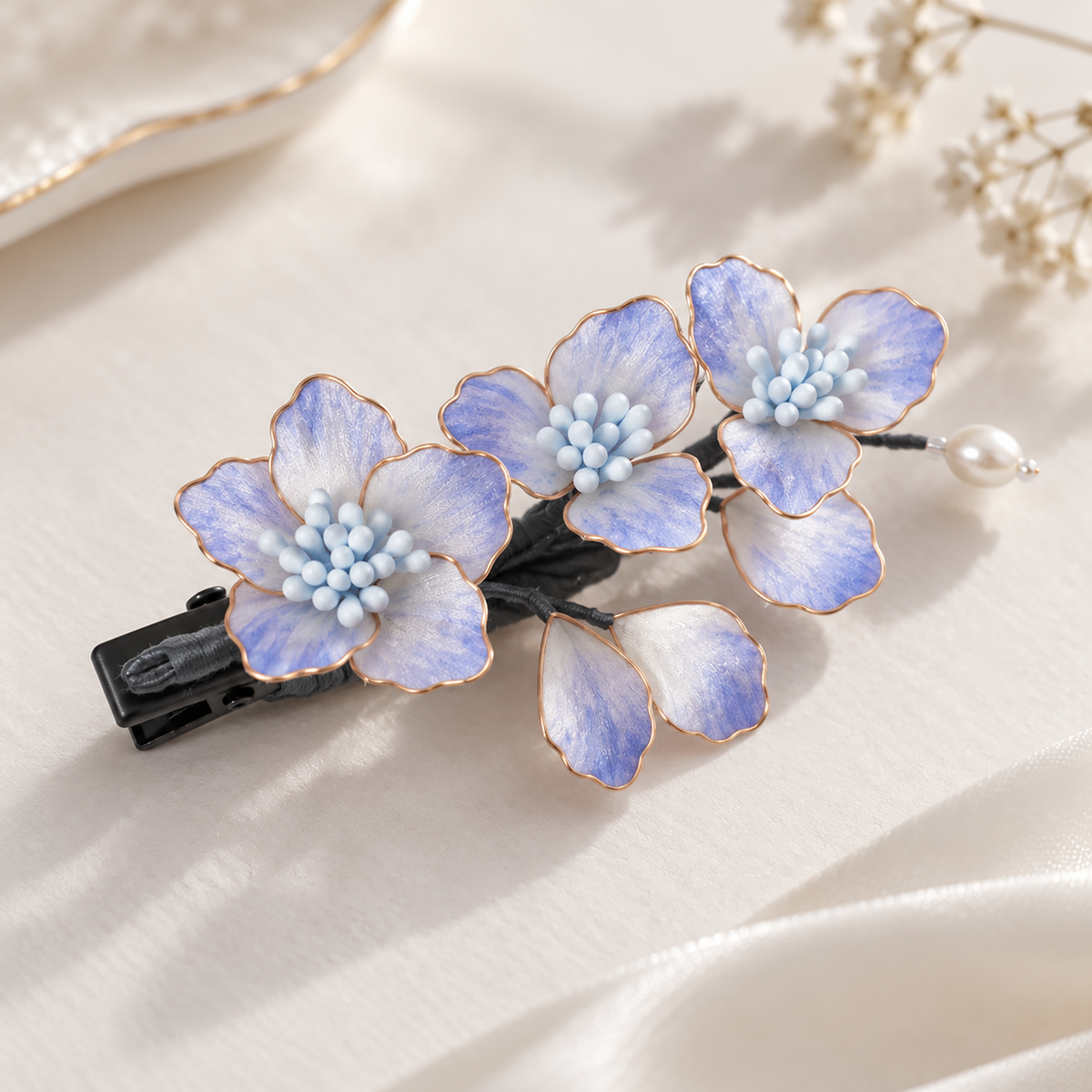 Lavender silk Ronghua hair clip with three blossoms and a pearl-like drop on cream fabric