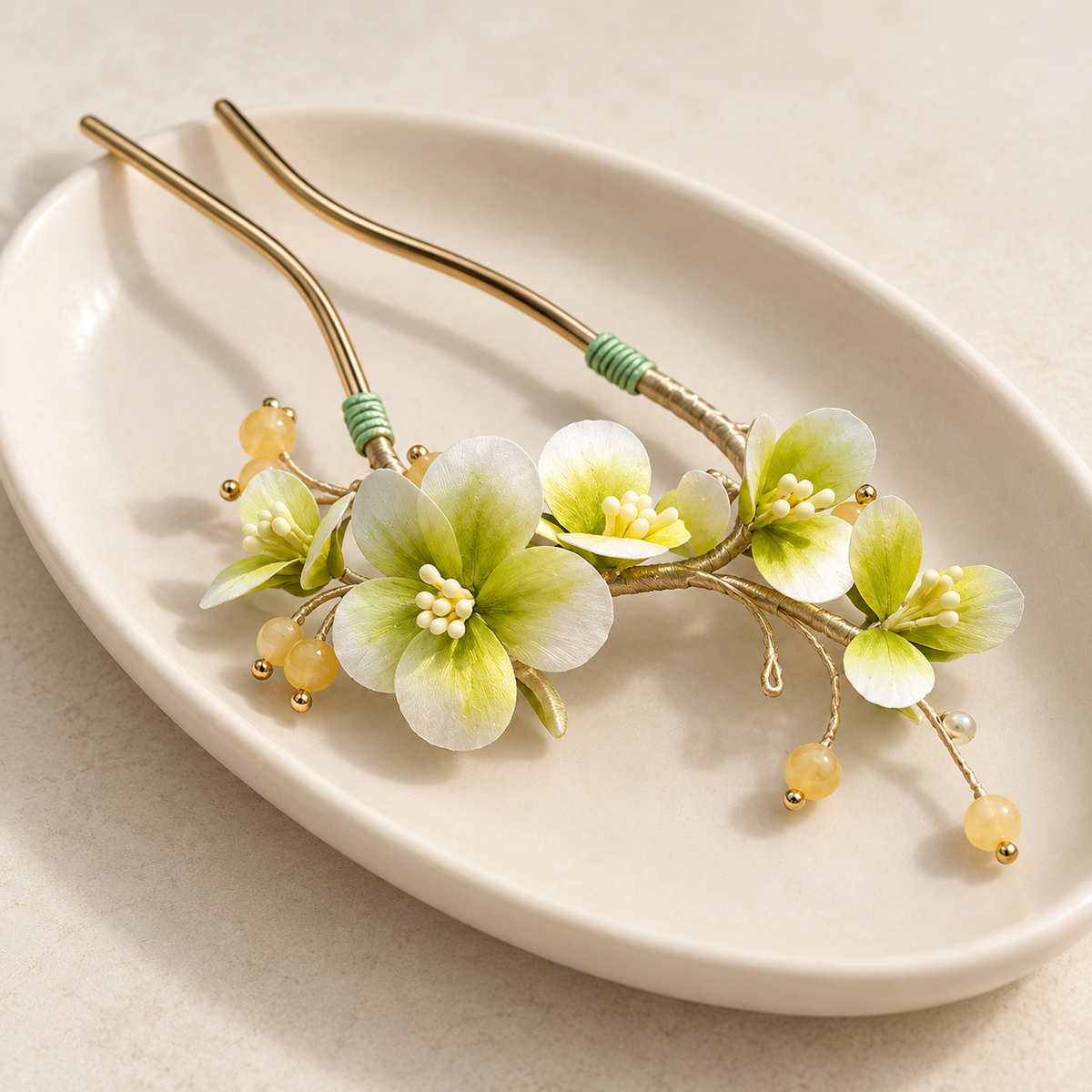 Green blossom Ronghua hair stick on a ceramic dish
