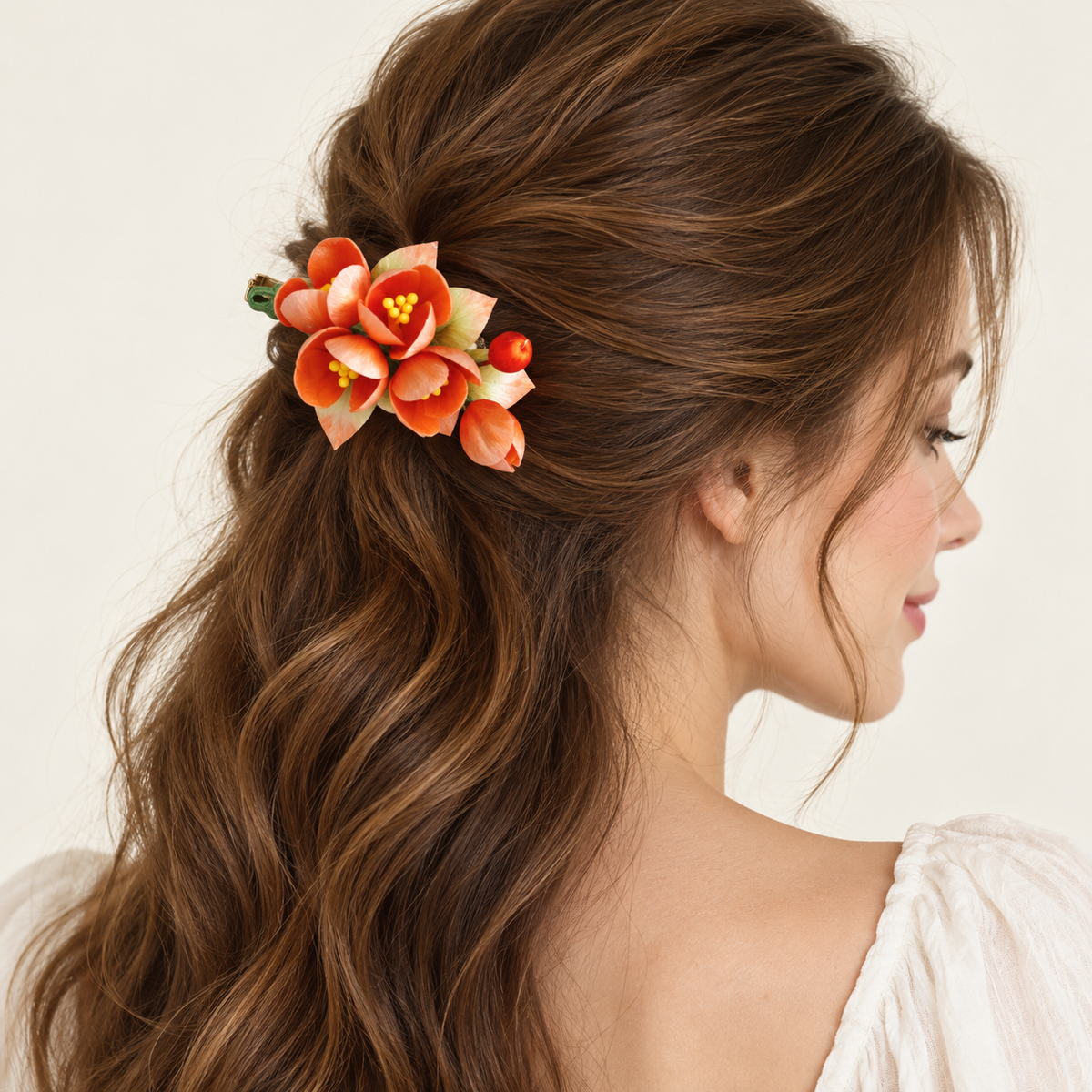Orange blossom hair clip worn in long wavy hair