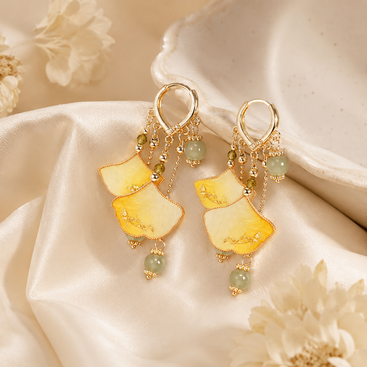 Golden ginkgo silk velvet dangle earrings with bead accents on cream satin