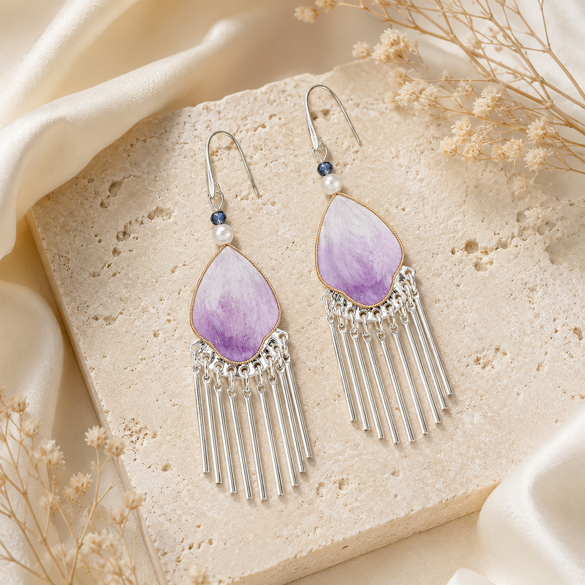 Pair of violet silk velvet tassel earrings with 925 silver ear hooks on stone display