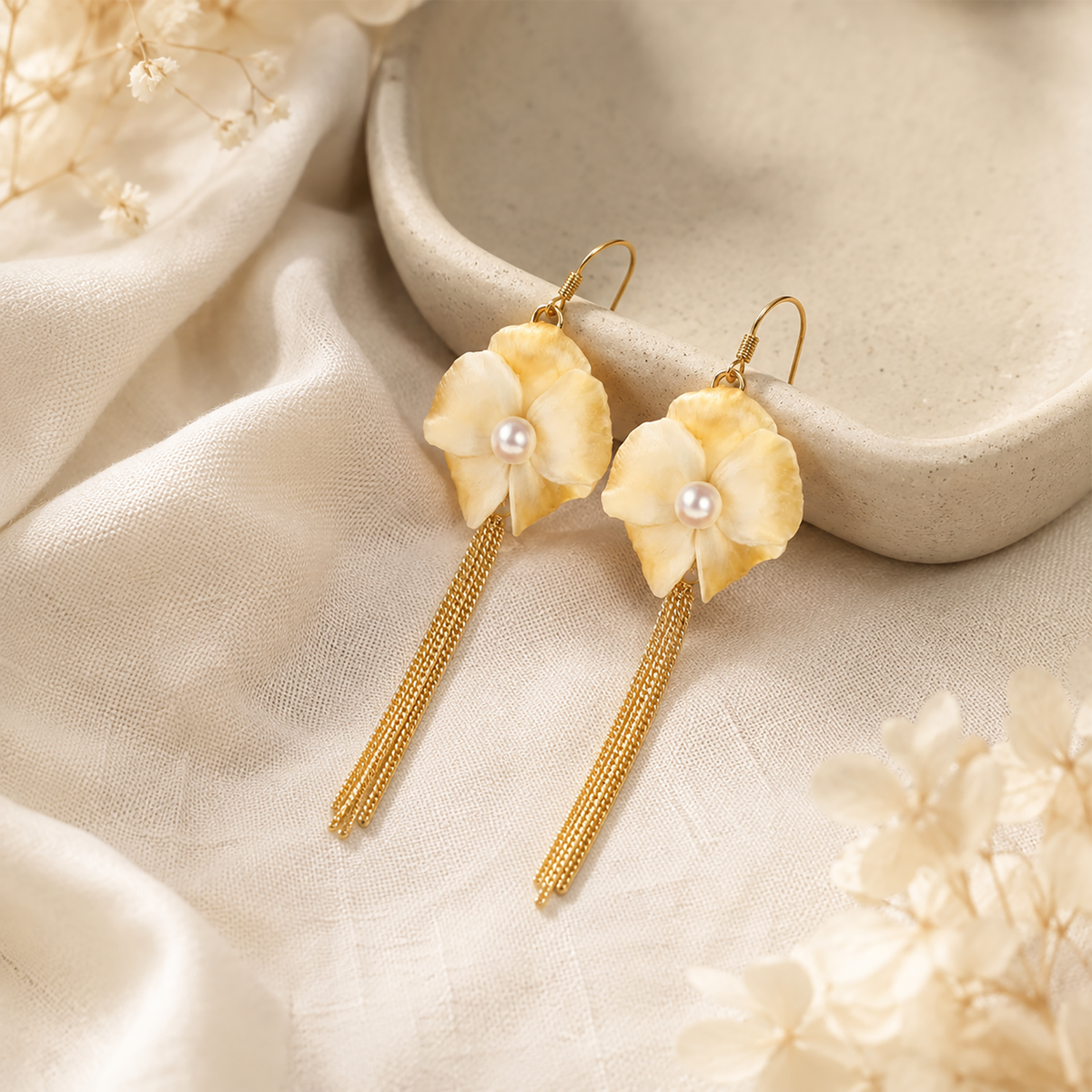 Pair of ivory silk velvet magnolia tassel earrings with pearl-effect centres and gold-tone chains