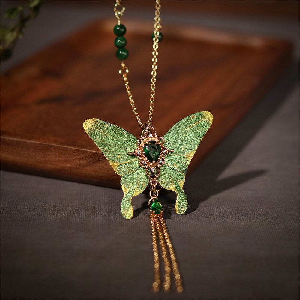 Side view of the butterfly pendant and suspended chains