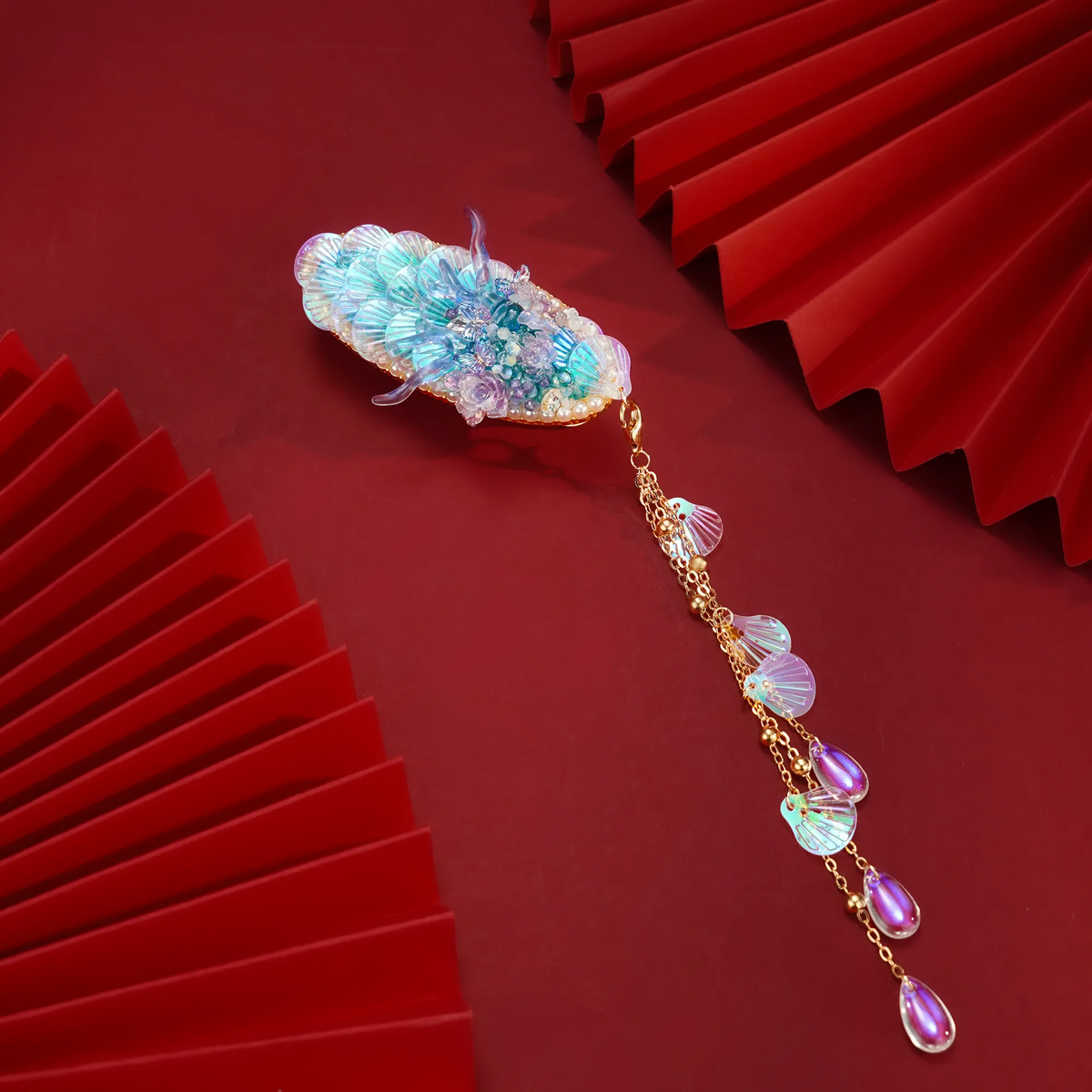 Ao Bing Dragon Hair Clip with cascading pendant on a red background