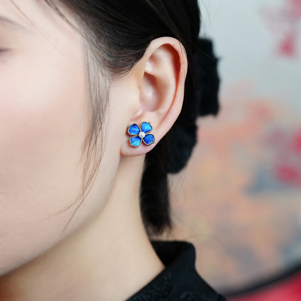 Blue Four-Leaf Clover Ronghua Stud Earring worn on the ear