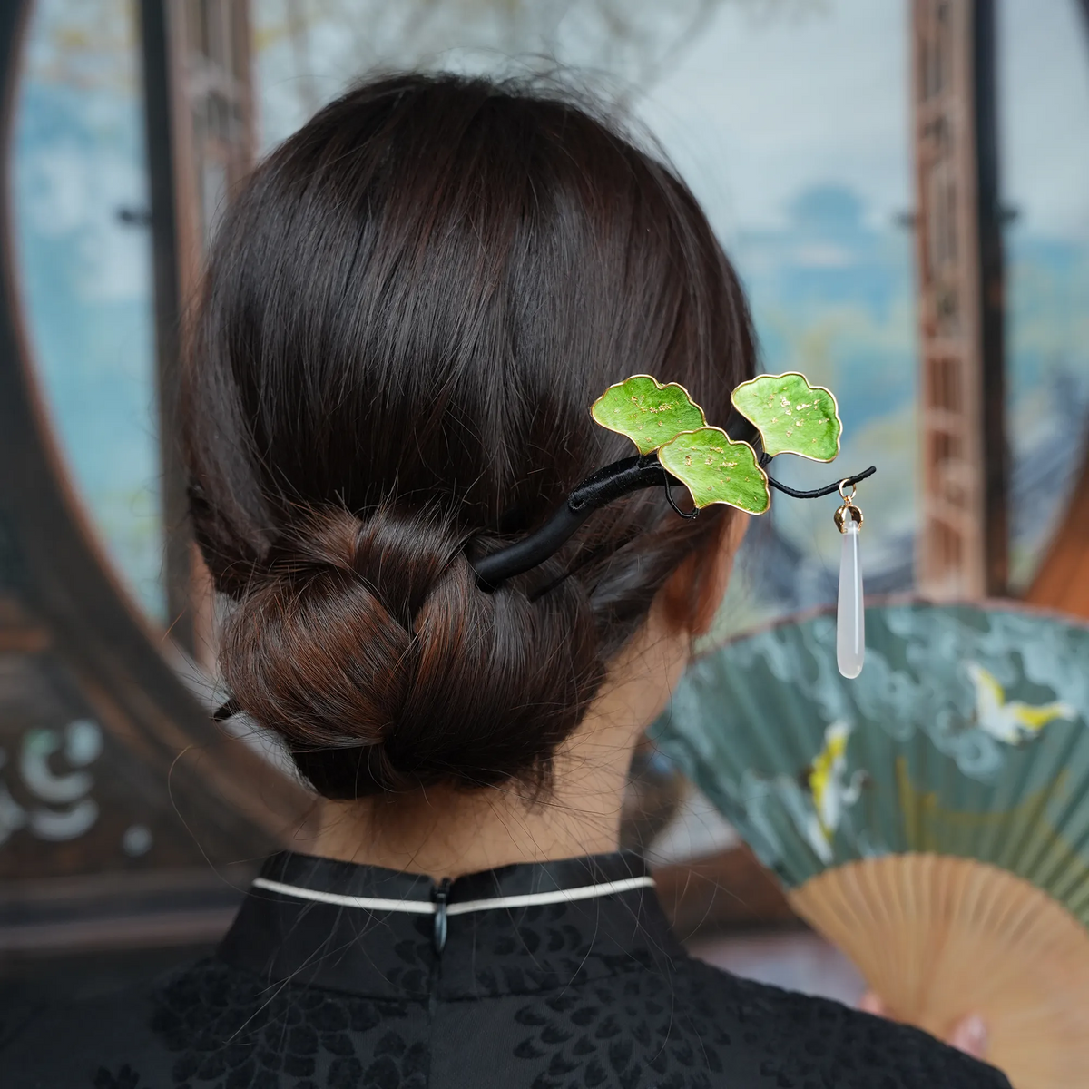 Green Ginkgo Ronghua Hairpin worn in a low bun