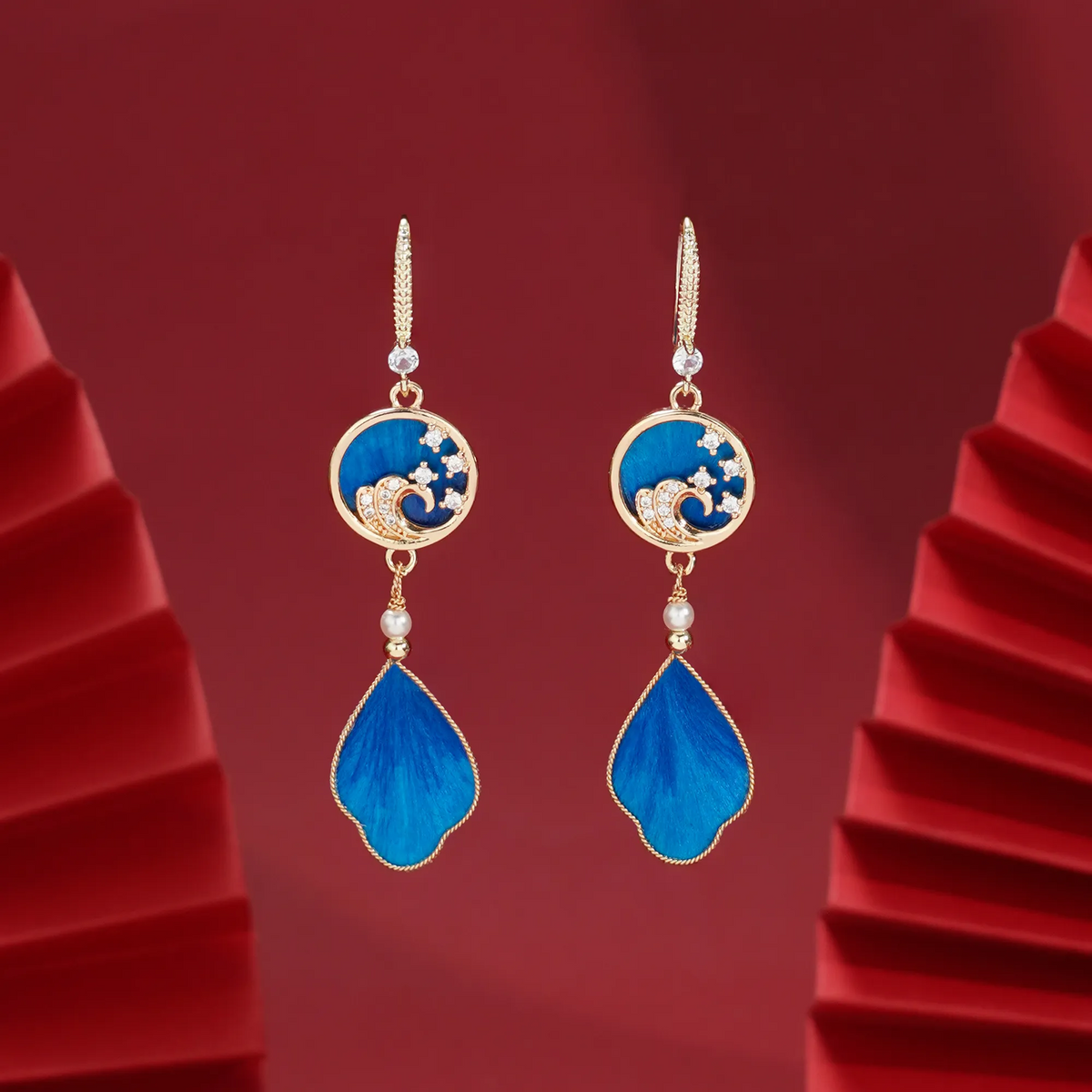 Pair of blue Canglan Wave Ronghua earrings showing shaped natural mulberry-silk fibre surfaces