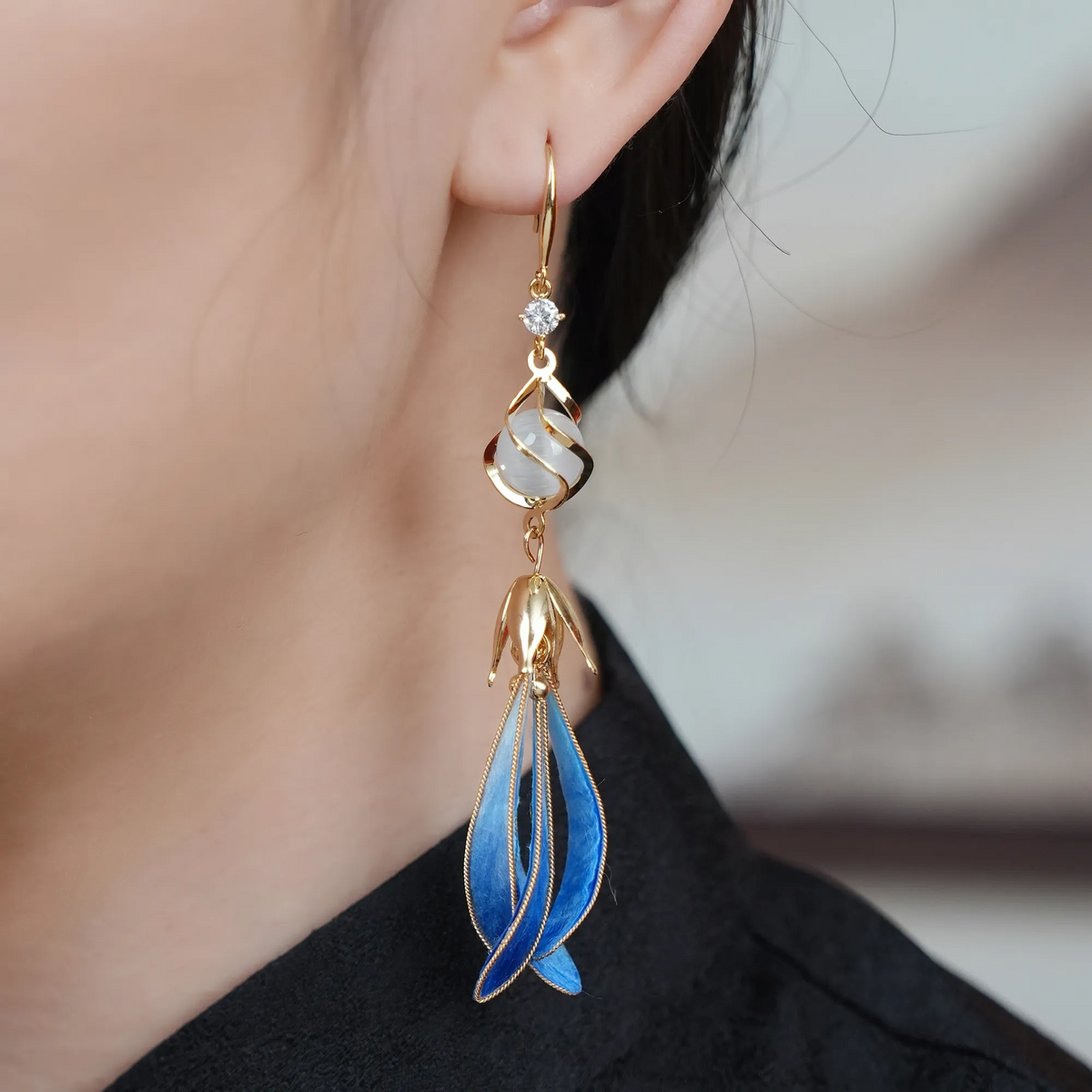 Close-up of blue ombré magnolia silk velvet drop earrings being worn