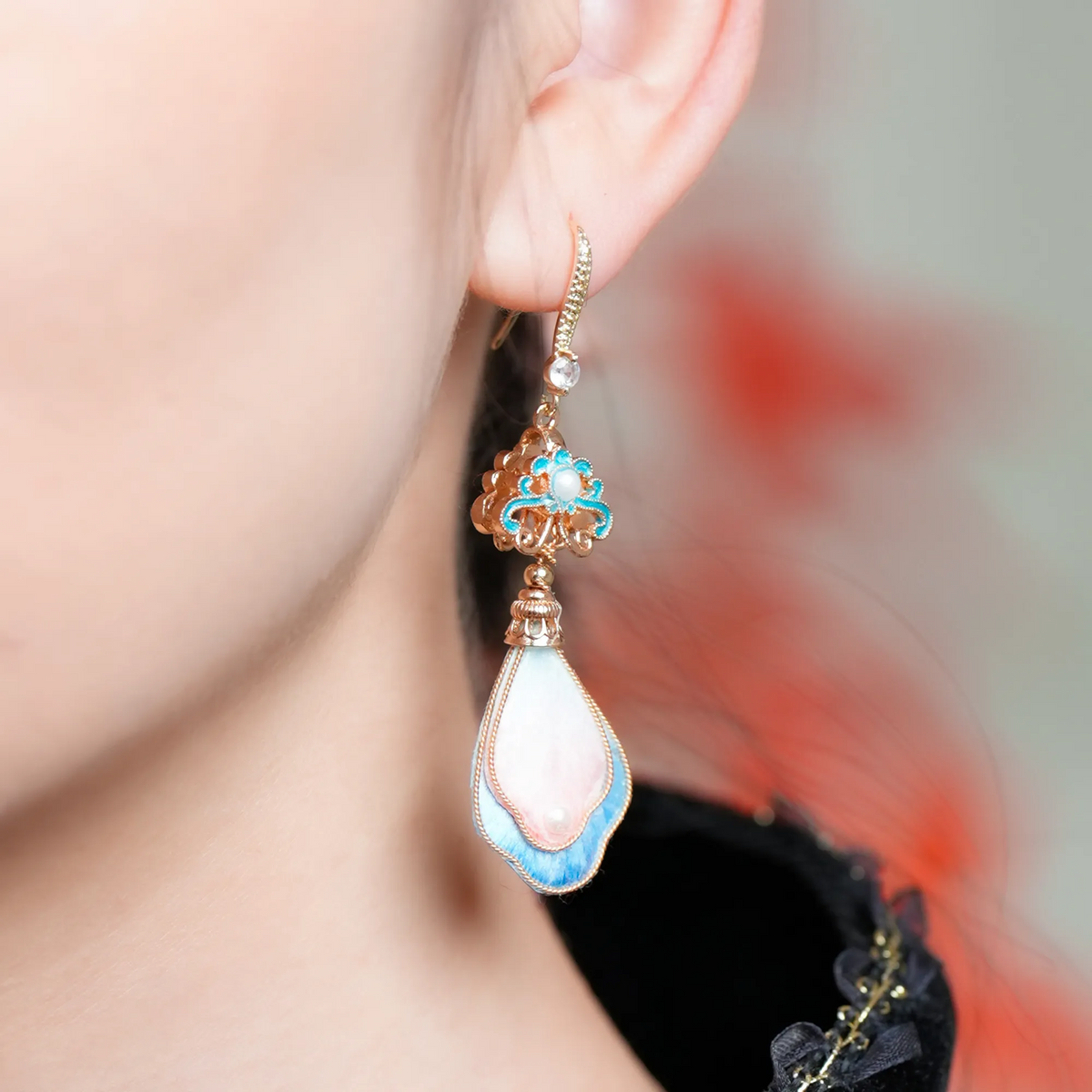 Close-up of pink peach blossom silk velvet earrings being worn