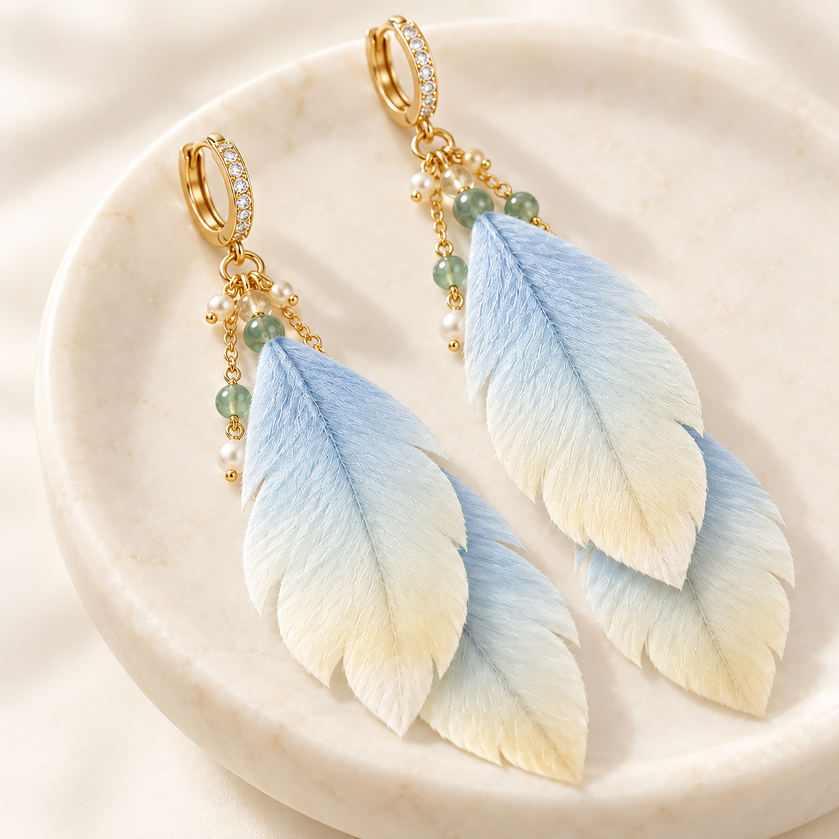 Close view of blue-to-ivory silk forms, gold-tone findings and pale beads