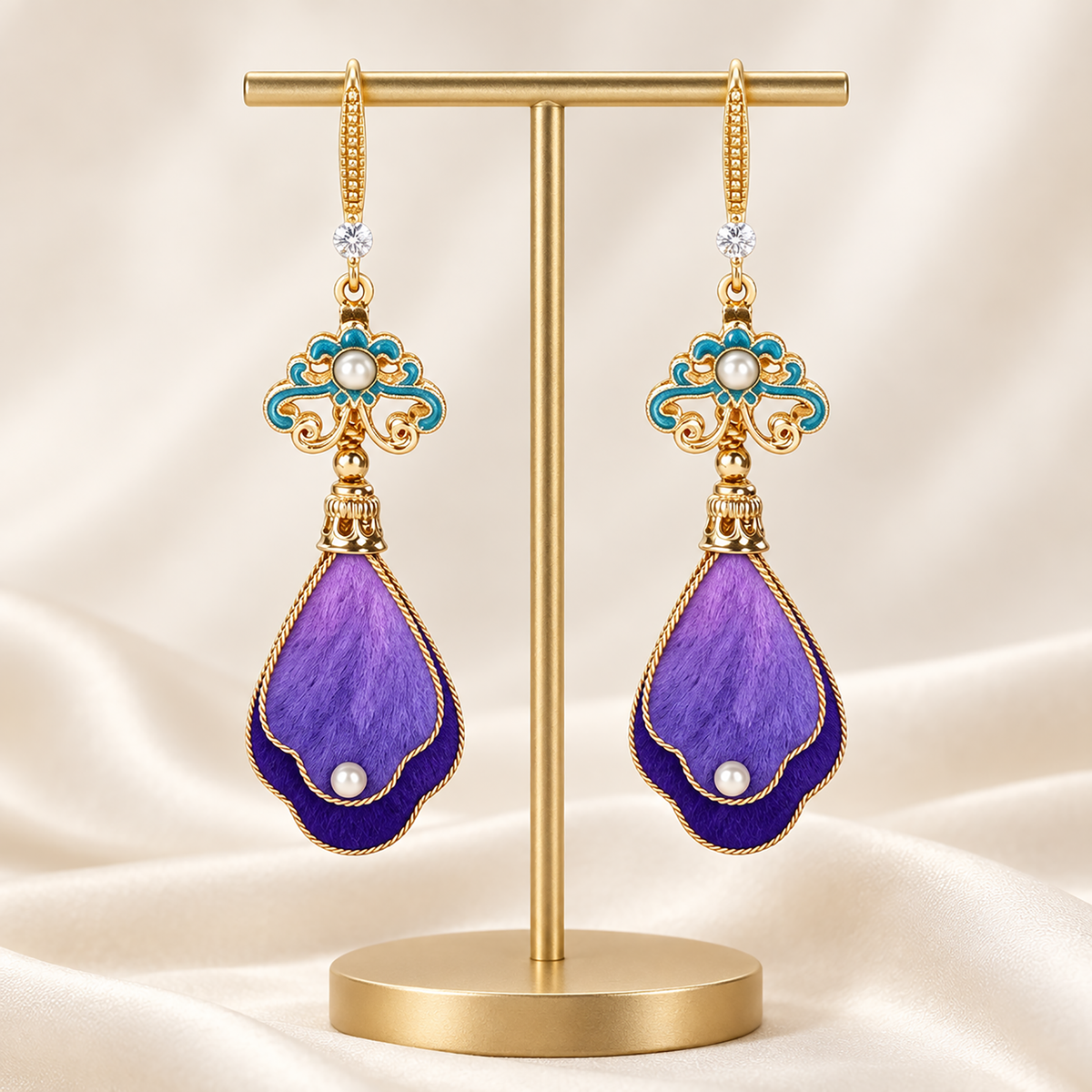 Close view of purple-indigo silk petals, turquoise enamel cloud and pearl-like accents