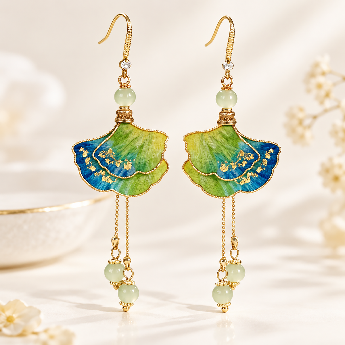 Close view of blue-green-yellow silk petals, gold speckles and pale green beads