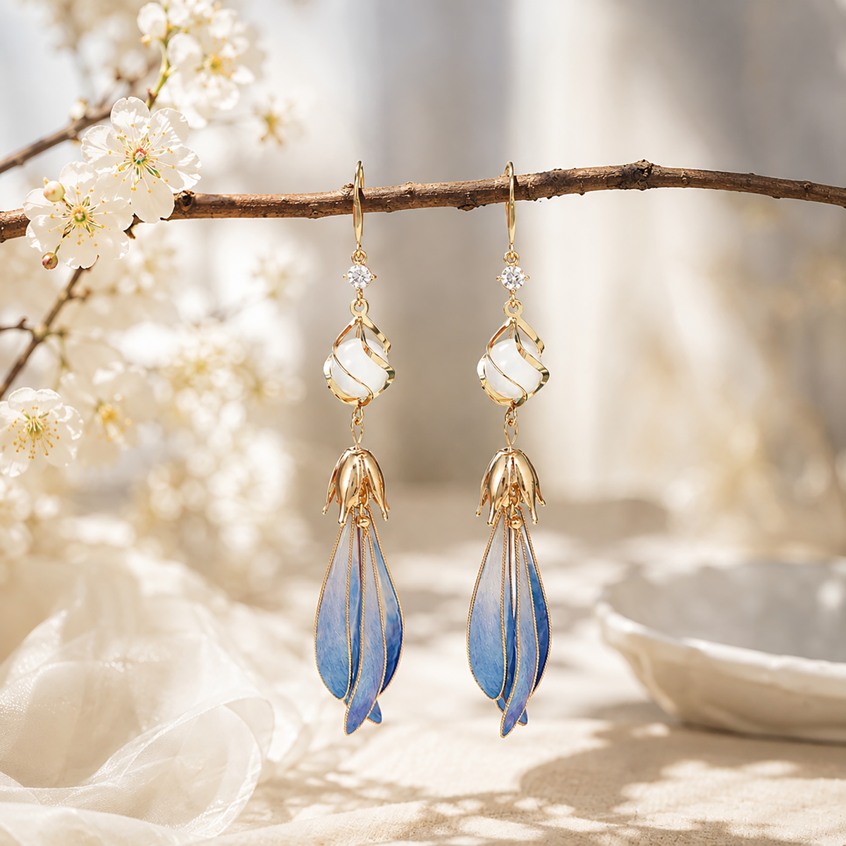 Blue ombré magnolia silk velvet earrings in a styled display