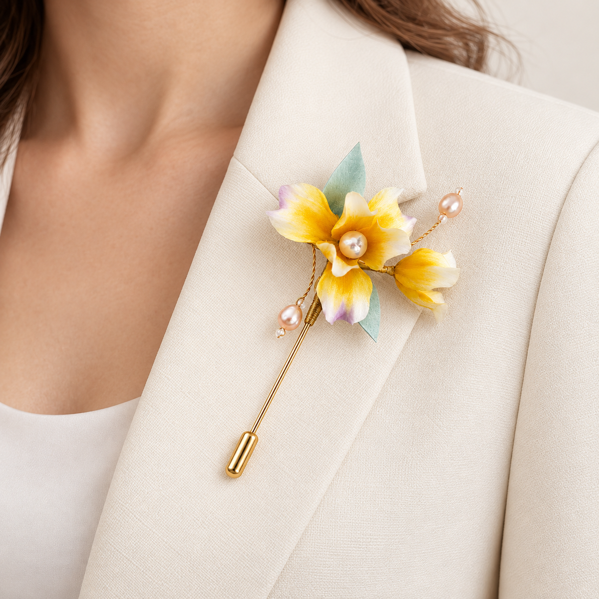 Yellow iris Ronghua brooch worn on a cream blazer lapel