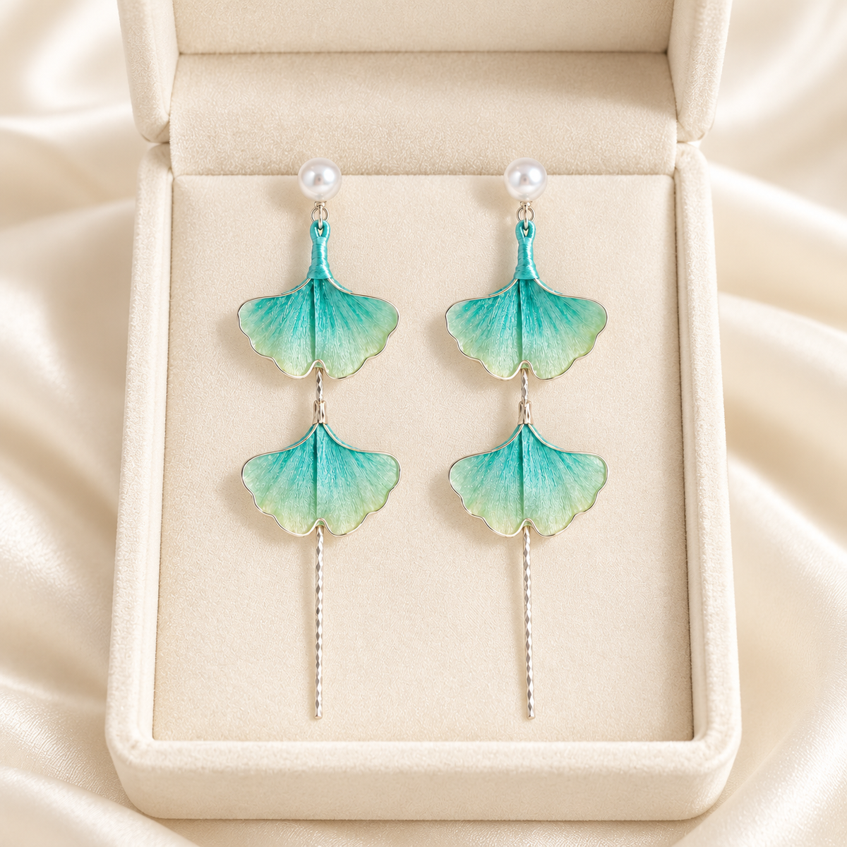Teal green ginkgo silk Ronghua stud earrings in a gift box