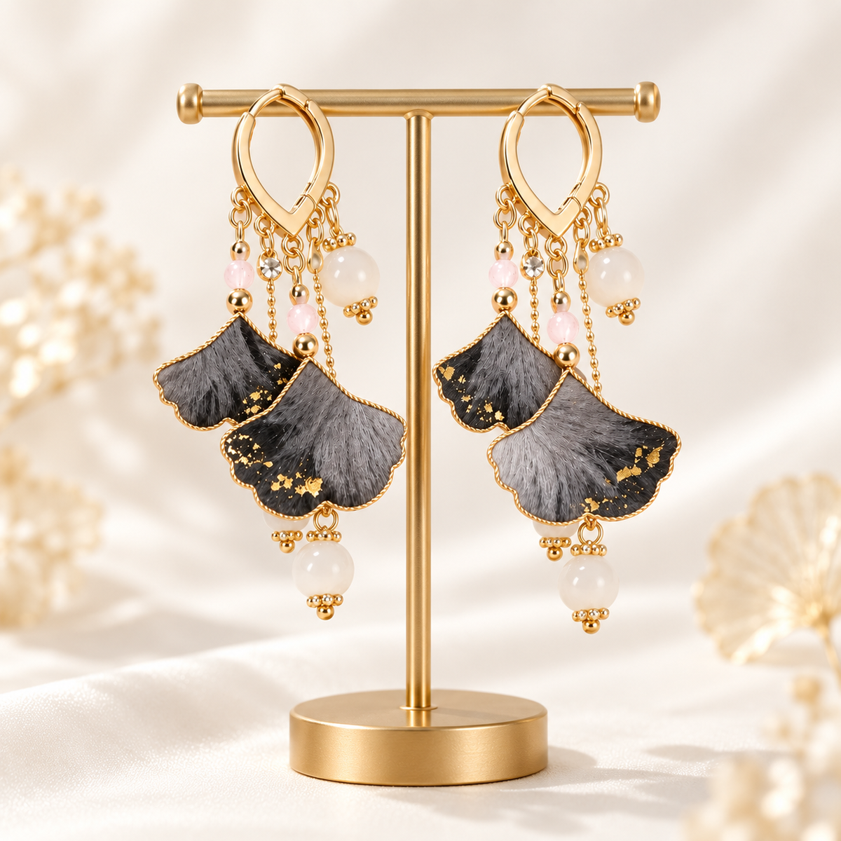 Shuangsheng ink ginkgo Ronghua drop earrings on a display stand