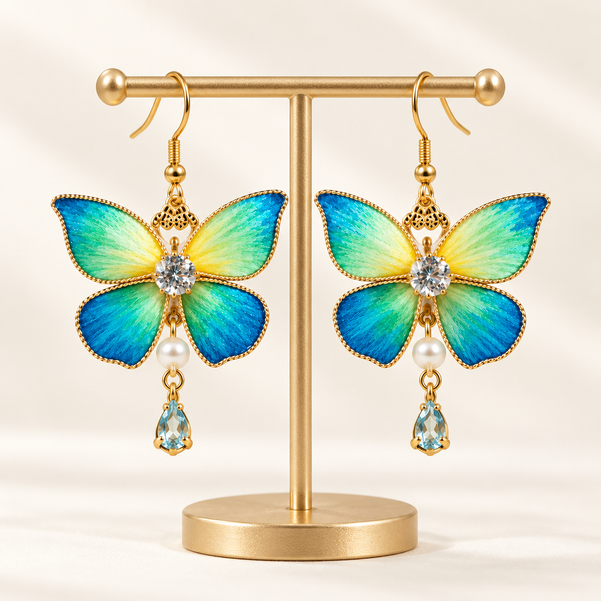 Blue-green butterfly Ronghua drop earrings on a display stand