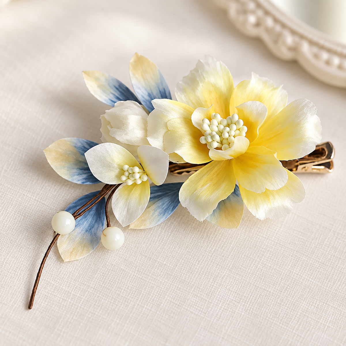 Yellow blossom hair clip on ivory linen showing the metal alligator clip
