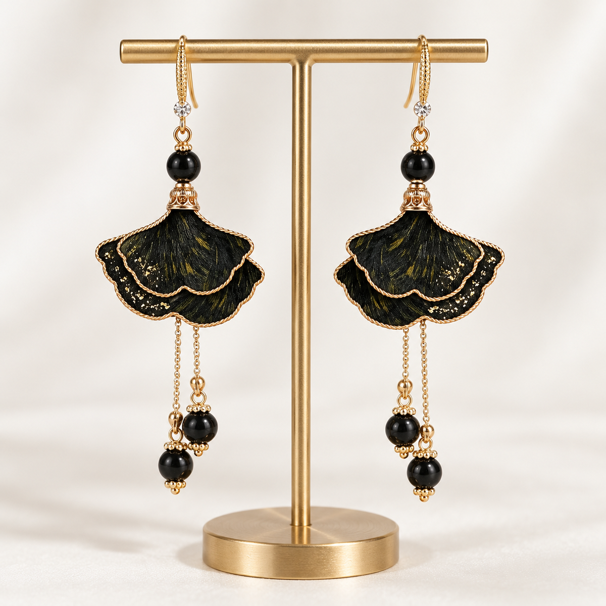 Ink-dyed ginkgo silk Ronghua drop earrings on cream fabric