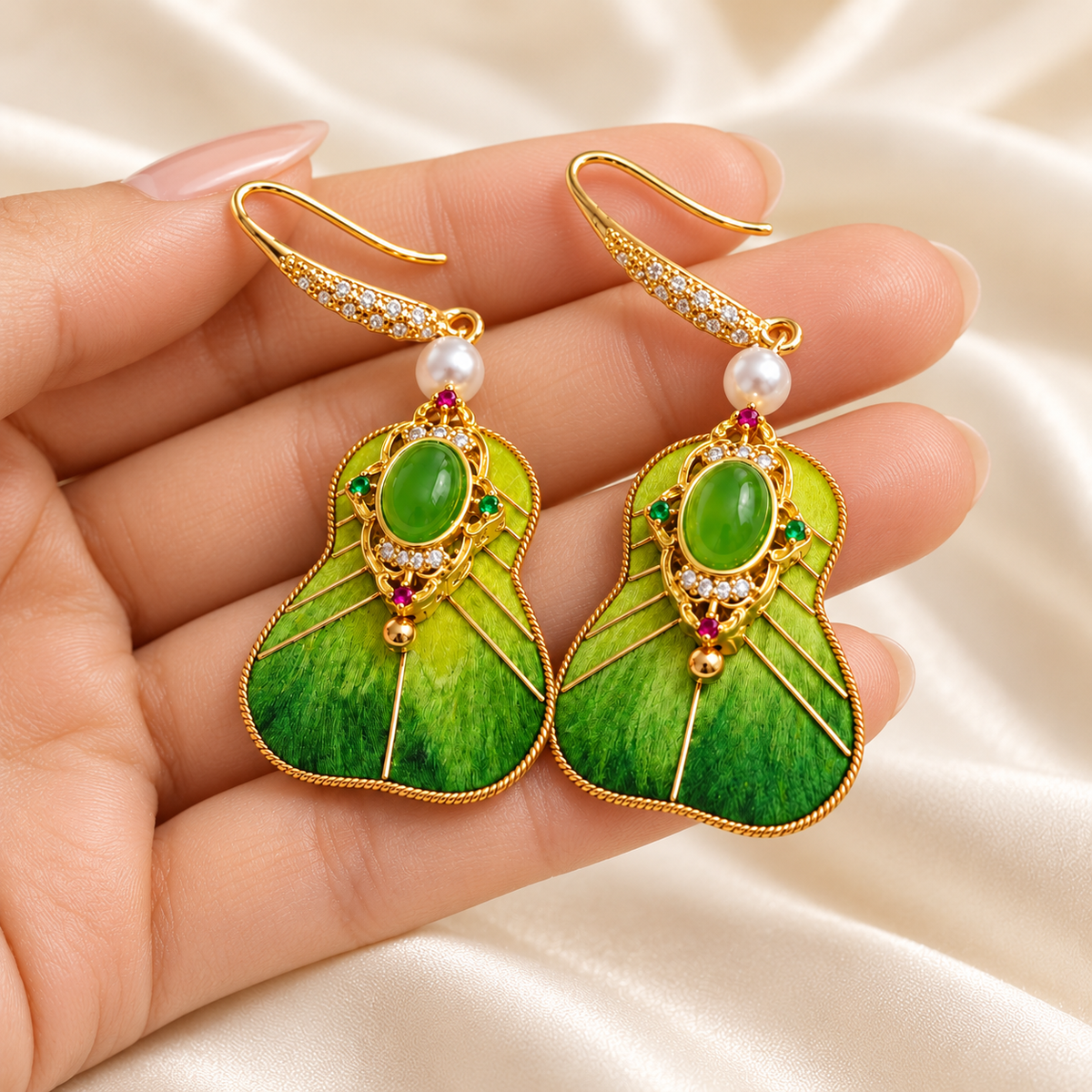 Cuiyu princess fan earrings held in hand