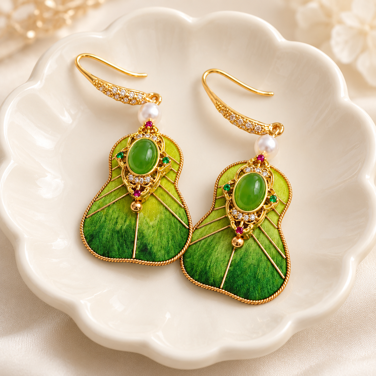 Green fan Ronghua earrings on a ceramic dish
