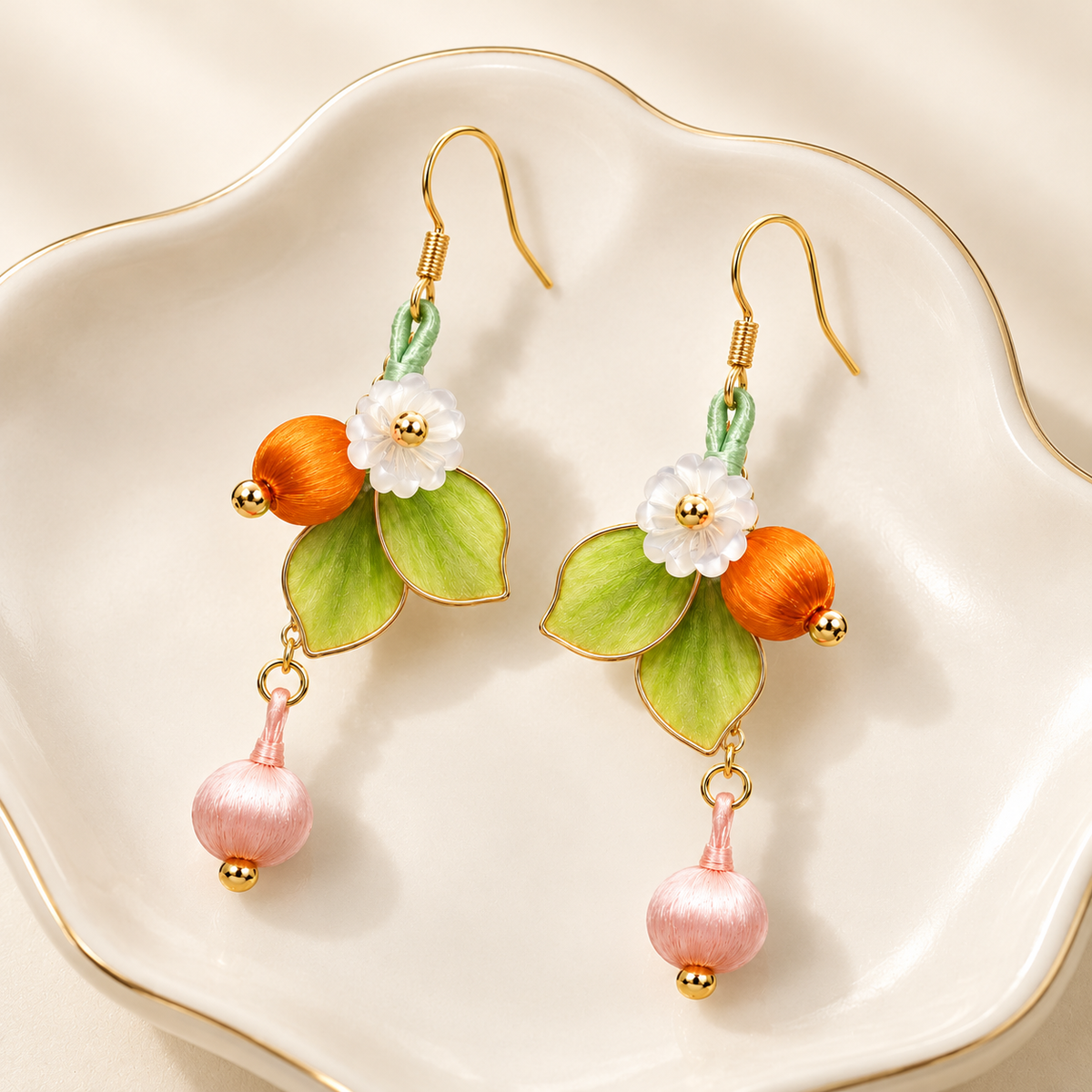 Forest blossom Ronghua drop earrings on a ceramic dish