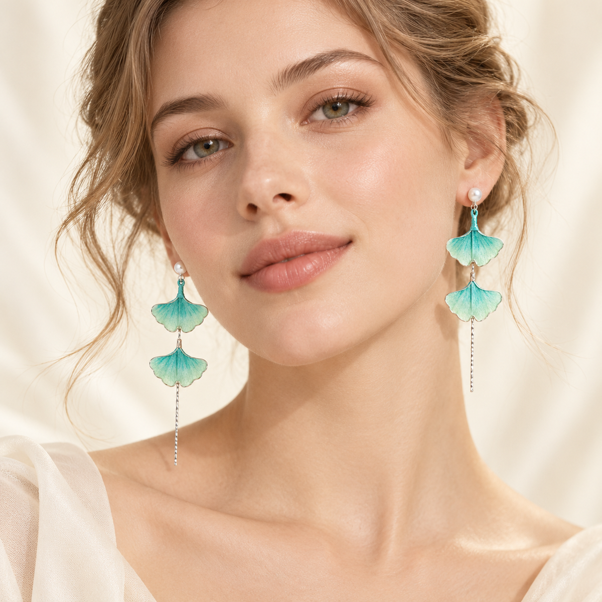 Teal green ginkgo Ronghua stud earrings worn, front view