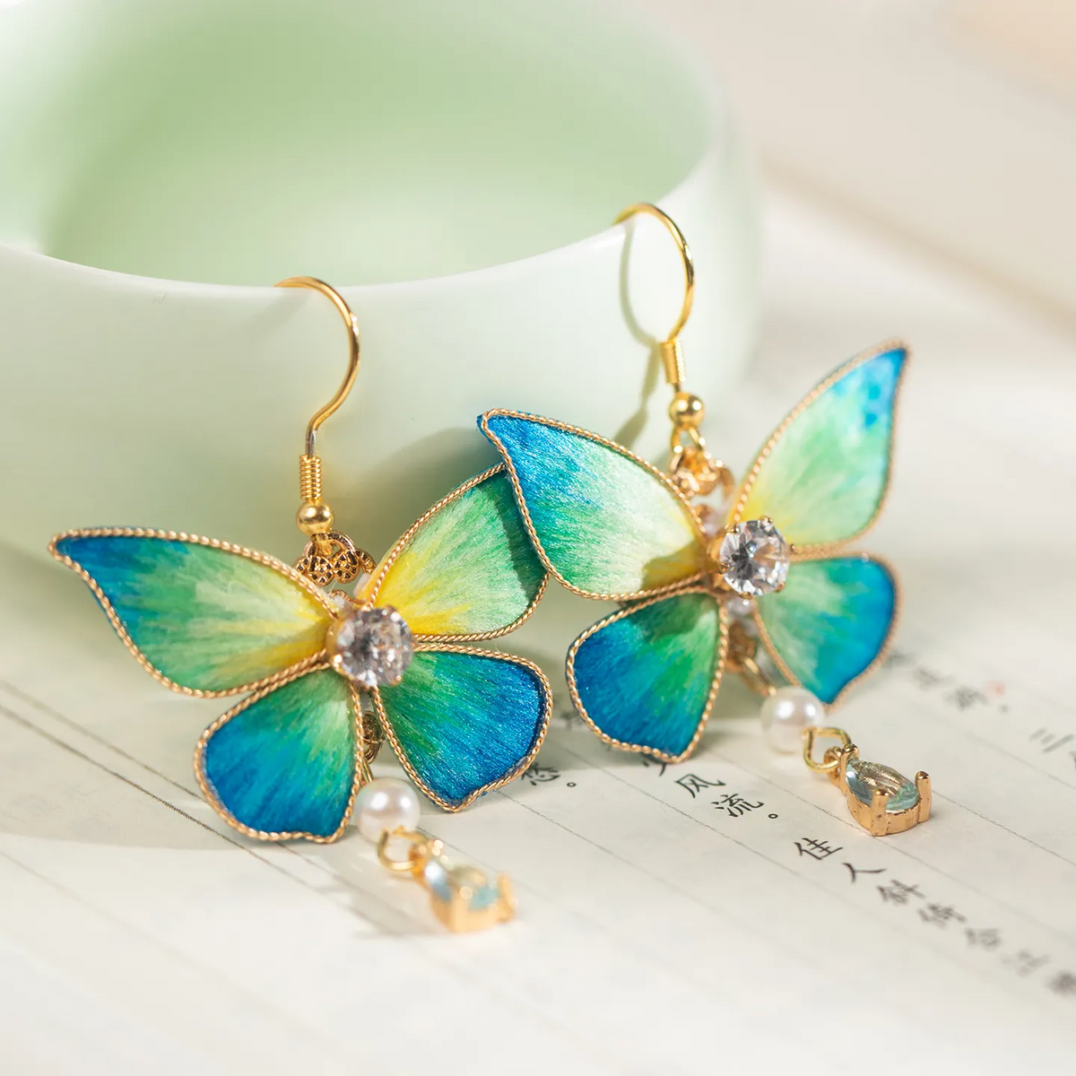 Qianli Jiangshan butterfly Ronghua earrings detail on calligraphy paper