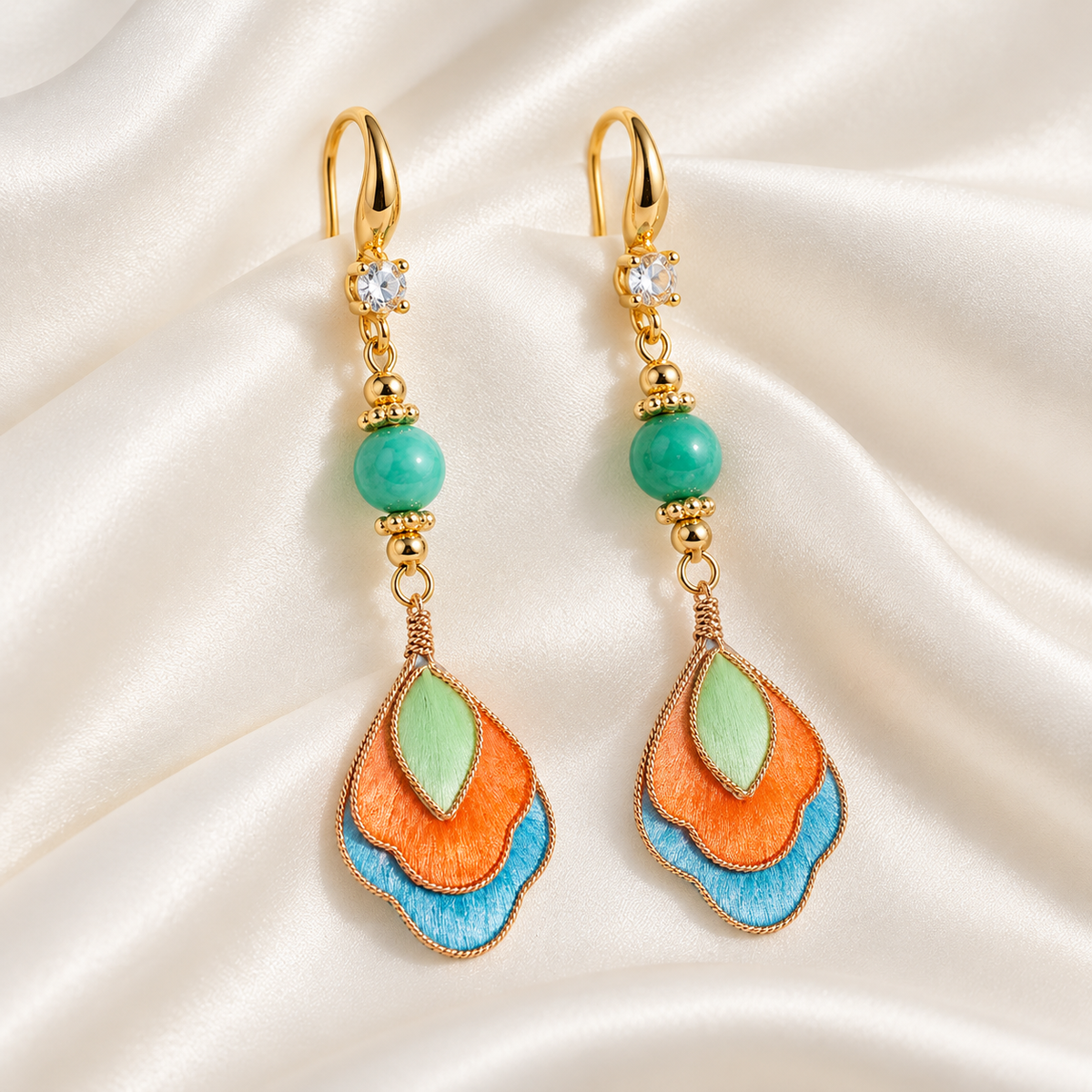Feitian Dunhuang silk Ronghua earrings on draped satin