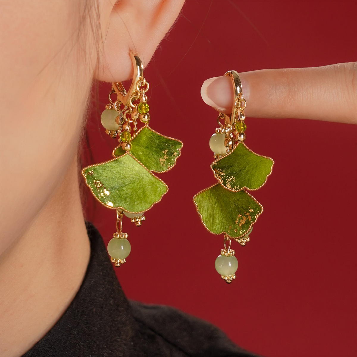 Woman wearing green ginkgo silk velvet dangle earrings by CLMADE