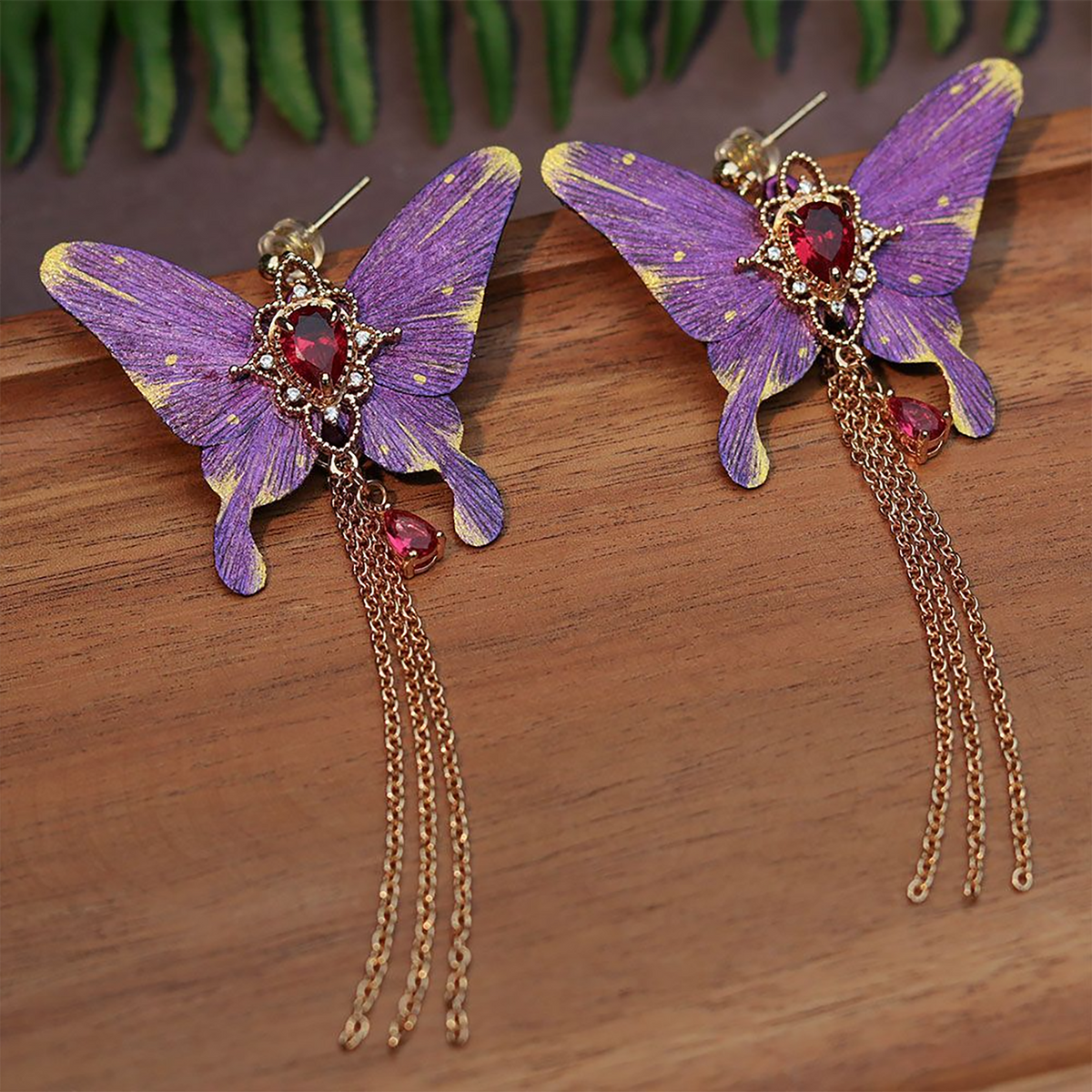 Purple silk velvet butterfly earrings showing the red-toned centre