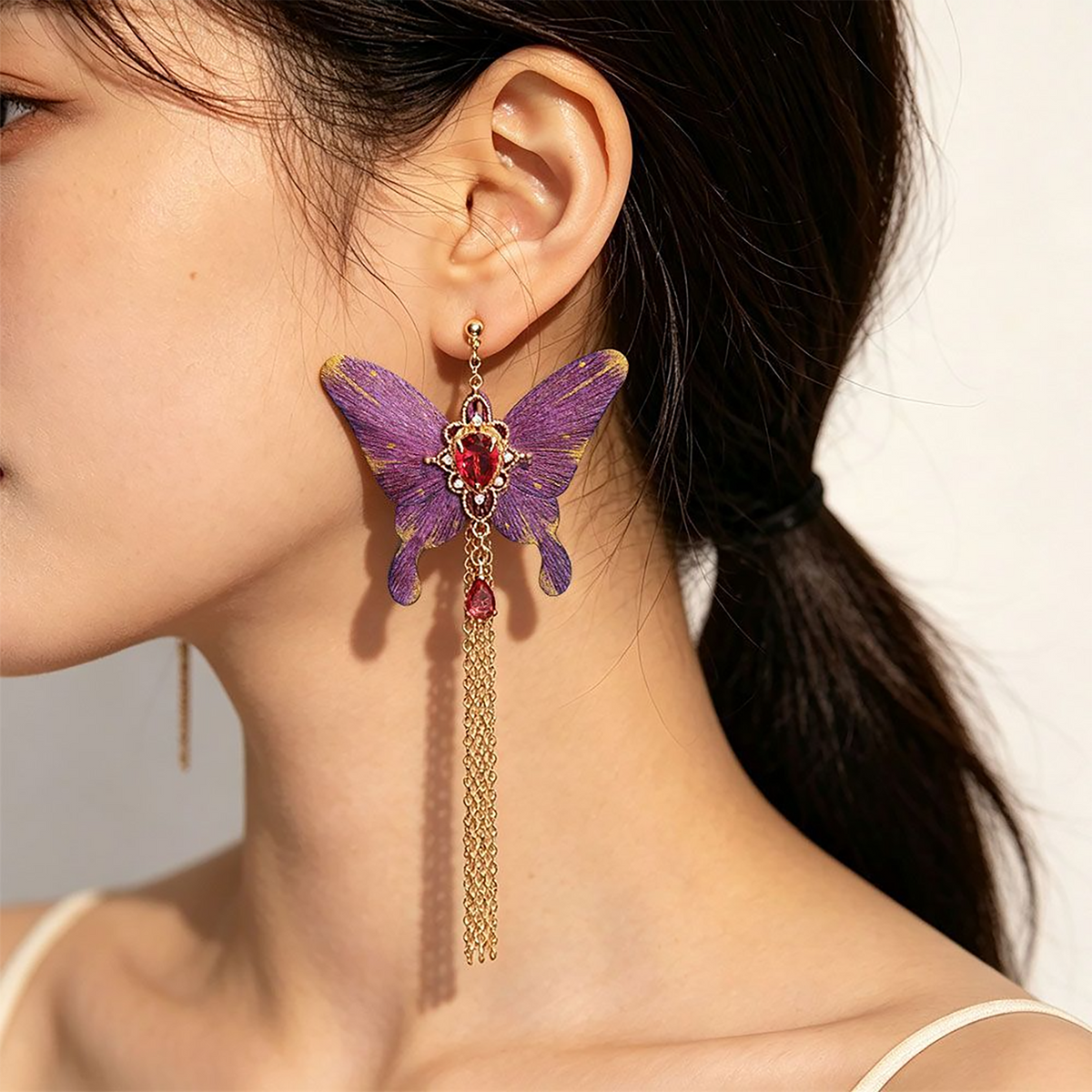 Model wearing purple butterfly silk velvet tassel earrings